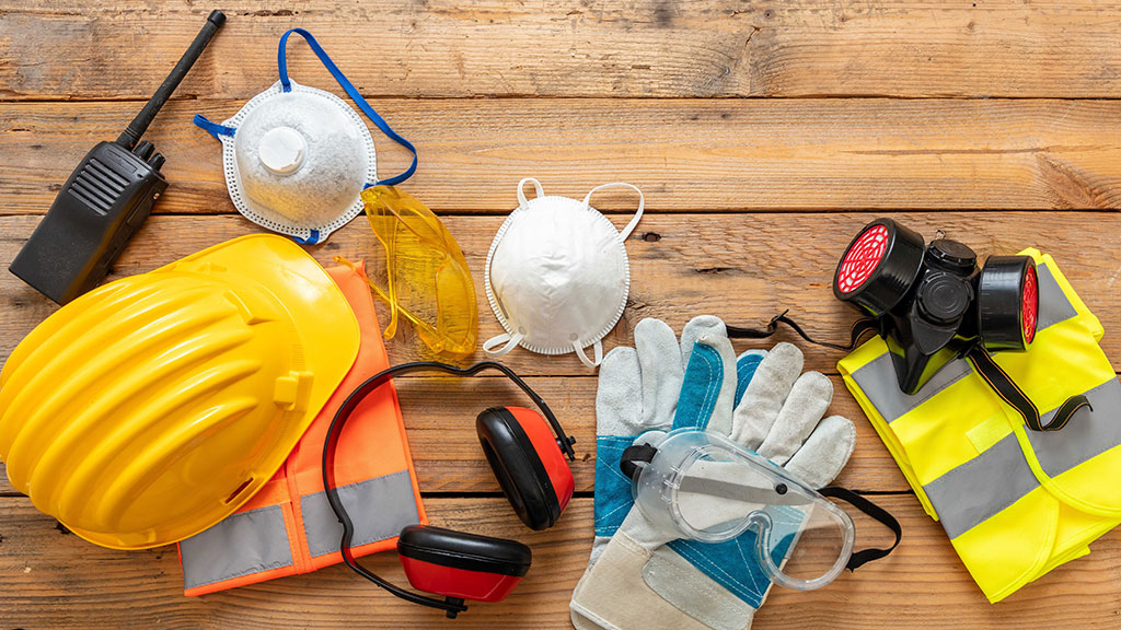 Assorted PPE equipment laid out on display on timber boards