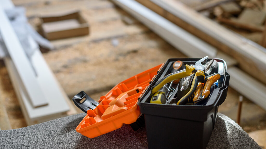 Open portable toolbox with hand tools at an apartment renovation site