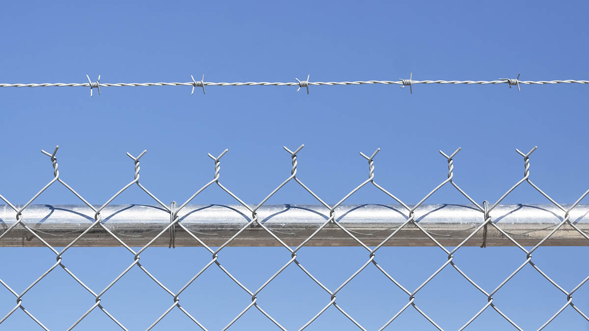 Chain link fencing with barbed wire