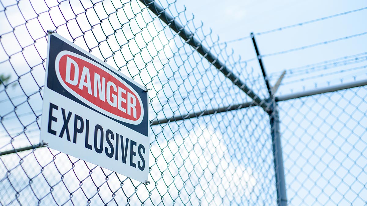 Chain link fence as security fencing with ‘danger explosives’ sign